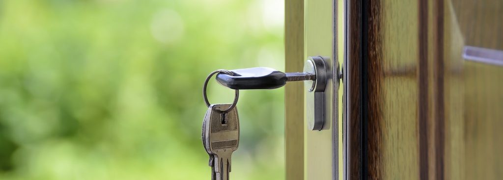 Keys and lock the door on the background of solar garden